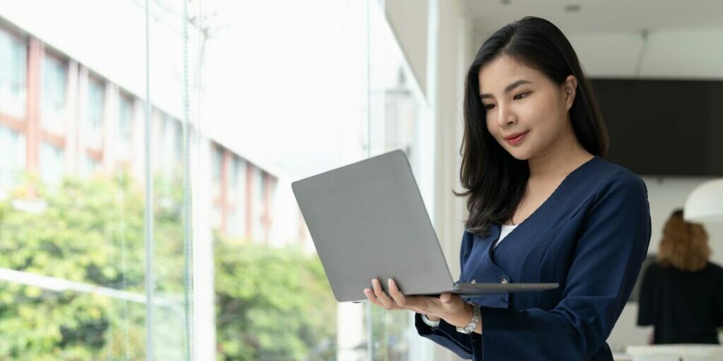 woman using the laptop while standing